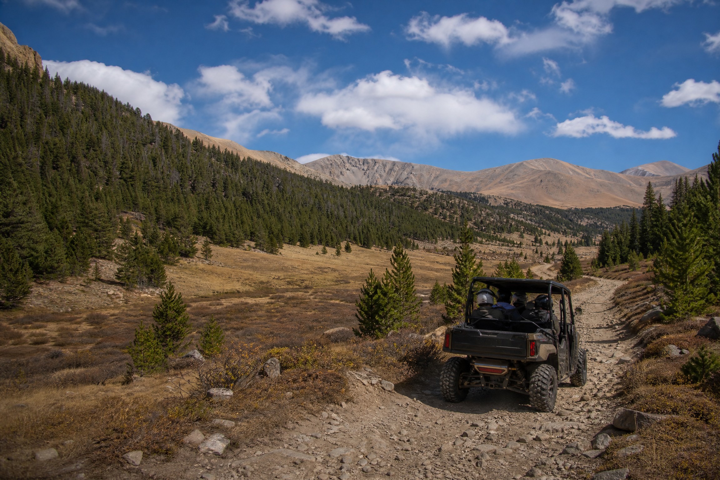 Side-by-side UTV riding in Colorado mountain terrain