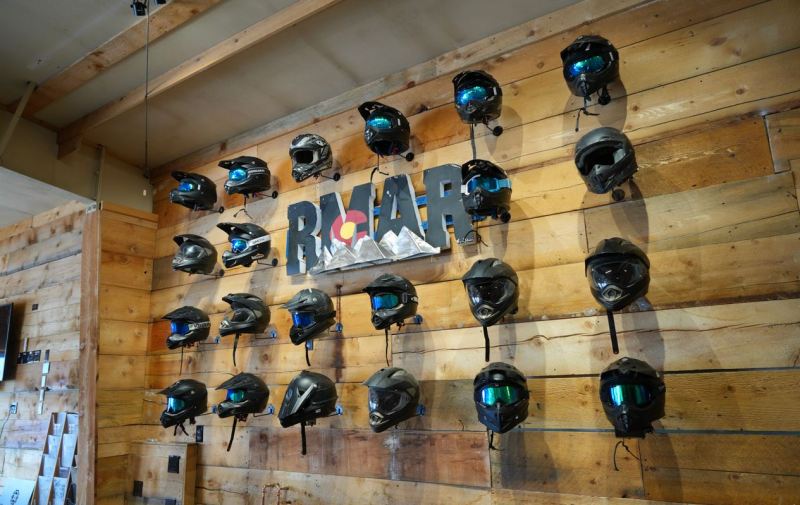 Wall of helmets prepared for Rocky Mountain Adventure Rentals riders