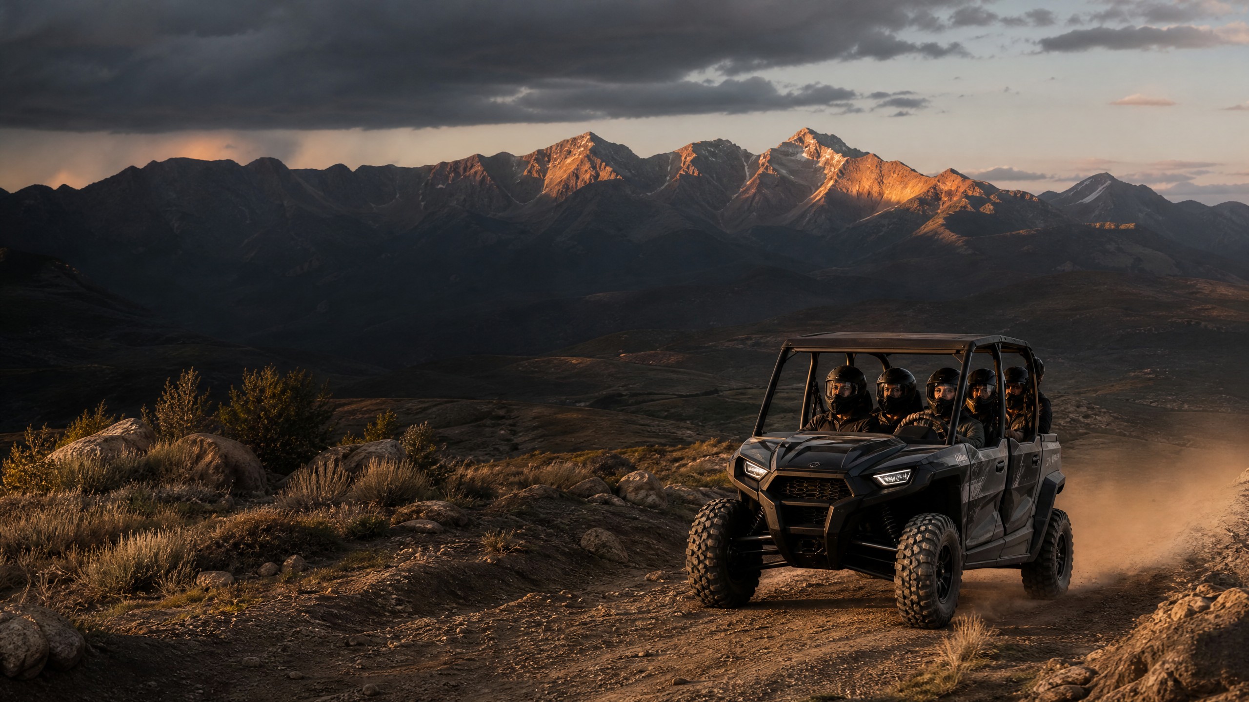 Four riders in a side-by-side UTV on a Colorado high-country trail at sunset