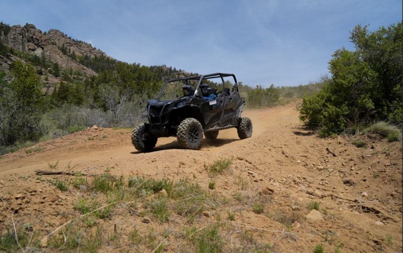 Black side-by-side UTV on an open dirt trail in Colorado backcountry