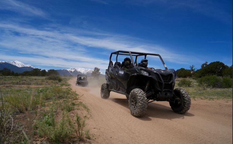 Side-by-side UTV on an open dirt trail near Colorado mountains